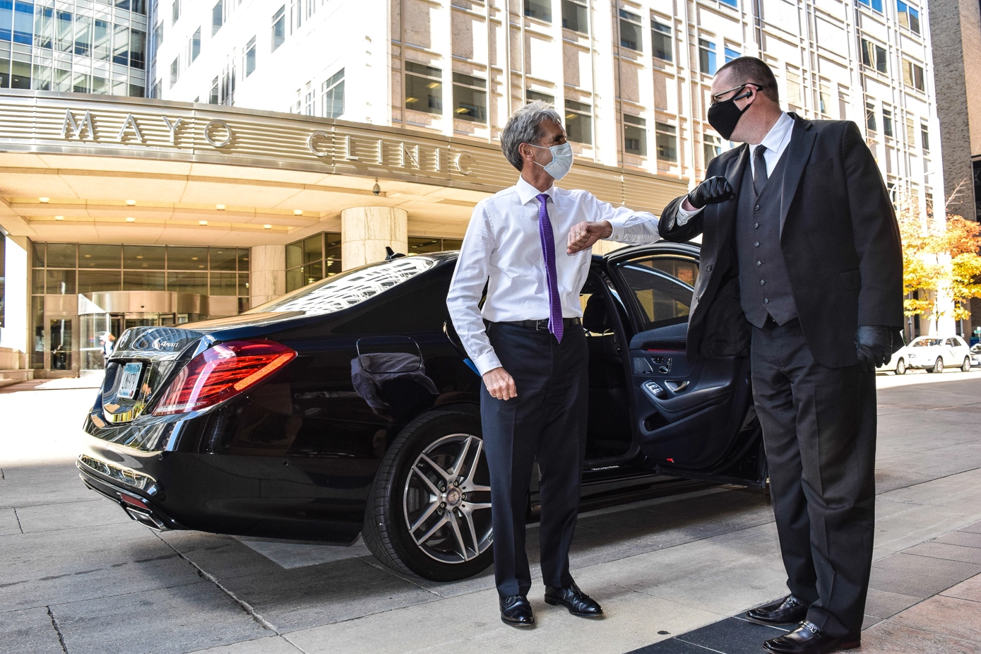 A picture of one of our chauffeurs greeting one of our customers before dropping off him at his destination