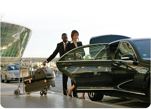 A picture of one of our chauffeurs assisting a customer at Detroit airport with luggage