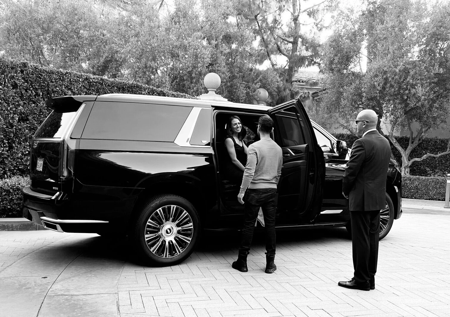 A picture of one of our chauffeurs picking up a family to take them to their destination