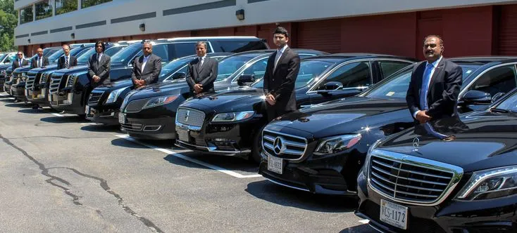 A picture of our chauffeurs standing next to their luxury vehicles which include sedans, suvs, and sprinters to accomodate for large group transportation